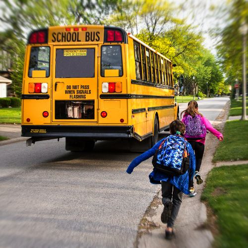 School bus and kids in neighborhood - stock